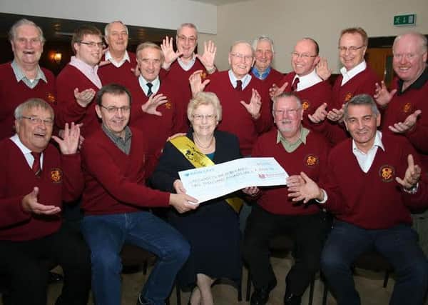 Sue Curtis with Colin Pursglove ( seated front second right) and Mirek Rus (seated front second left) and choir members at the cheque presentation