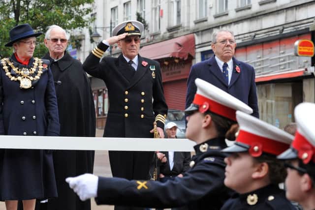 Mansfield Remembrance Service.Cmd Peter Moore, Mansfield Mayor Kate Allsop and Mansfield MP Alan Meale take the salute in the town centre following a service at St. Peter's.