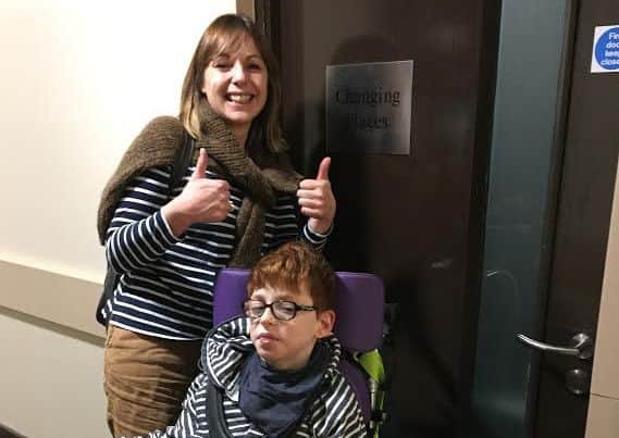 Alison Beevers and Mylor outside an accessible Changing Places toilet