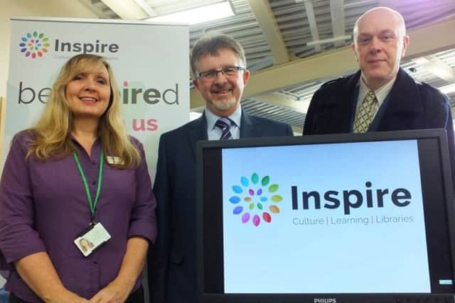 Library assistant Denise Hall, Leader Councillor Alan Rhodes and Councillor John Knight