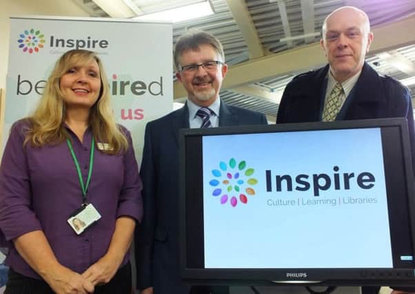 Library assistant Denise Hall, Leader Councillor Alan Rhodes and Councillor John Knight