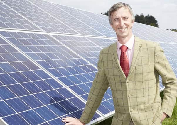Charles Cannon, of Ransomwood, with the solar panels they have installed.