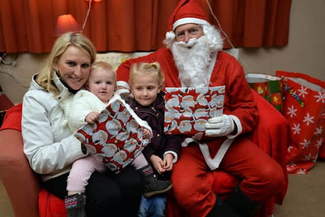 Brinsley Christmas fair, pictured with Santa are Emma Haywood with daughters Amber, one and Lucie, four