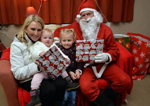 Brinsley Christmas fair, pictured with Santa are Emma Haywood with daughters Amber, one and Lucie, four