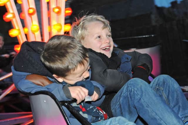 Stanton Hill lights switch on.                                 Sol and Finlay Locker take a spin on one of the fairground attractions.