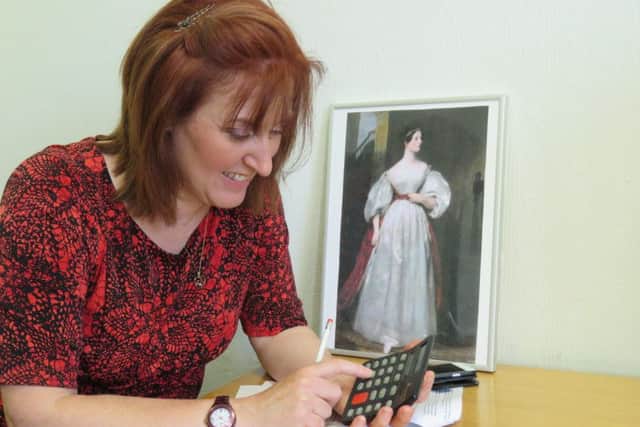 Leader of Ashfield District Council, Councillor Cheryl Butler, ponders over some fiendish maths puzzles using a calculator. Ada Lovelace's work inspired the invention of the calculator.