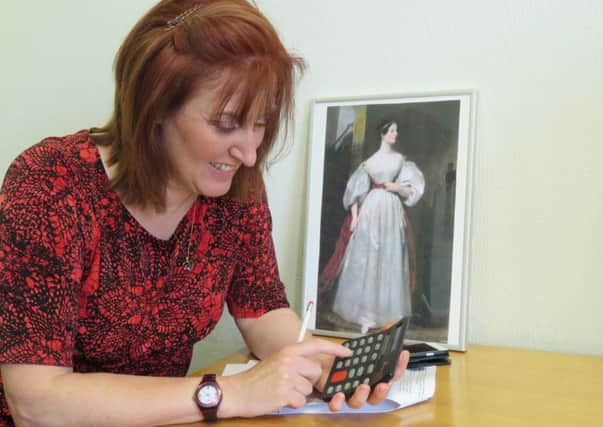 Leader of Ashfield District Council, Councillor Cheryl Butler, ponders over some fiendish maths puzzles using a calculator. Ada Lovelace's work inspired the invention of the calculator.