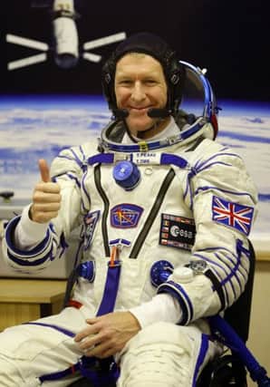 British astronaut Tim Peake gives a thumbs up during suit pressure testing following suiting up on the Baikonur Cosmodrome in Kazakhstan, ahead of today's launch to the International Space Station. PRESS ASSOCIATION Photo. Picture date: Tuesday December 15, 2015. See PA story SCIENCE Peake. Photo credit should read: Gareth Fuller/PA Wire