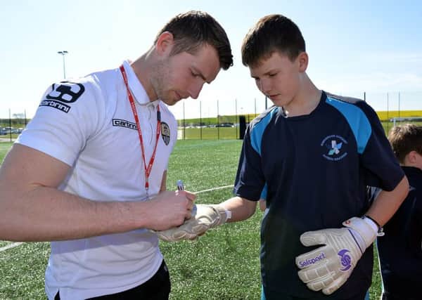 Notts County footballers visited Shirebrook Academy as part of the schools language week, pictured signing a glove is goalkeeper Fabian Spiess