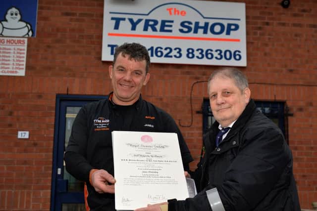 Royal Humane Society award presented to James McGinley owner of The Tyre Shop, Ollerton from Robert Farrier for helping him following a car accident, James is pictured recieving his award from Robert