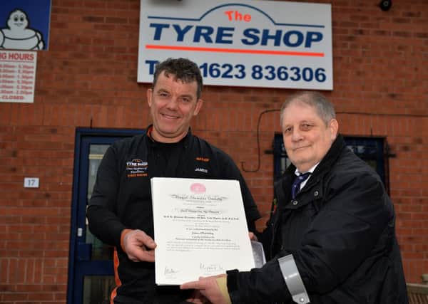 Royal Humane Society award presented to James McGinley owner of The Tyre Shop, Ollerton from Robert Farrier for helping him following a car accident, James is pictured recieving his award from Robert