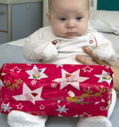 Empire Boxing Club have been helping the family of the late Corah Slaney deliver presents to the Childrenâ¬"s Ward at Kings Mill Hospital, Sutton-in-Ashfield. Emily Sheldon, 12weeks, from Alfreton, with one of the presents