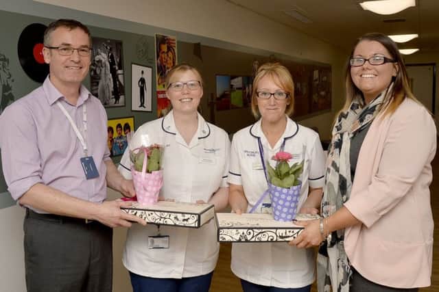 Dr Steve Rutter and Catherine Cheyne presenting Lorraine Brooks and Joanne Lewis-Hodgkinson with prizes for both suggesting the winning entry in the name the ward competition for th enew dementia ward at King's Mill Hospital.