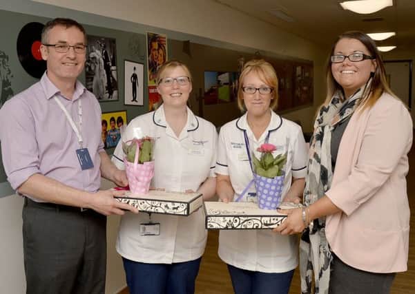 Dr Steve Rutter and Catherine Cheyne presenting Lorraine Brooks and Joanne Lewis-Hodgkinson with prizes for both suggesting the winning entry in the name the ward competition for th enew dementia ward at King's Mill Hospital.
