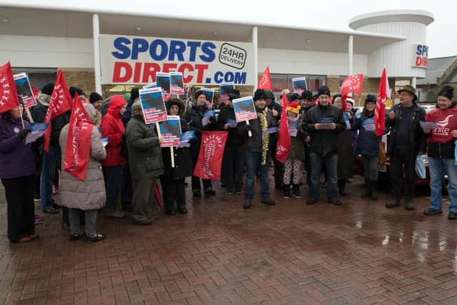Campaigners sing a hymn about exploitation outside Sport Direct store in Mansfield