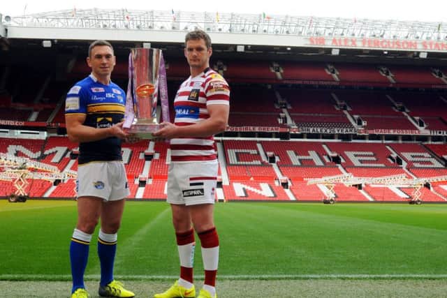 Leeds Rhinos captain Kevin Sinfield, left, and Wigan Warriors captain Sean O'Loughlin, holding the Super League trophy ahead of the 2015 Grand Final.