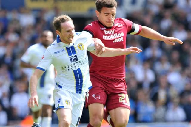 Aidan White and Mason Bennett challenge for the ball.Leeds United v Derby County.  SkyBet Championship.  3 May 2014.  Picture Bruce Rollinson