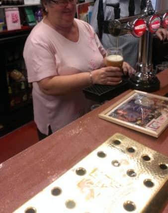Pulling pints at Boothy's.