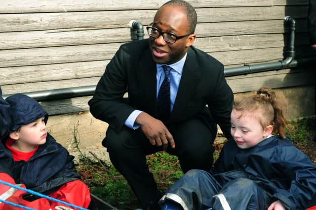 Childcare and Education Minister Sam Gyimah visits the Haxby Road Primary Academy in York, to announce the eight councils who will deliver 30 hours of free childcare for hard working parents of three- and four-year-olds from September 2016, a year ahead of schedule. Pictured in the forest schools class chatting to Bailey Brittain and Evie Langan.2nd Febuary 2016.Picture : Jonathan Gawthorpe