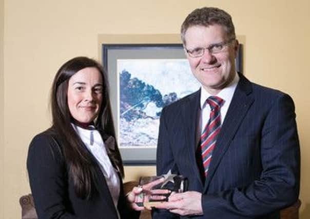 Photo by Neil Denham 
Melissa Brown receiving the 'Accountant of the Year award from Vertu Motors CEO, Robert Forrester