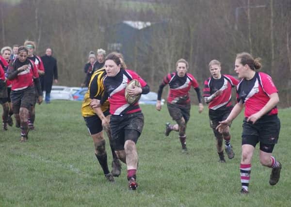 ON THE RUN -- Harry Gibbs surging forward for Ashfield Ladies during their victory.