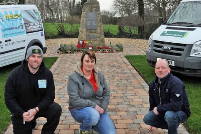 Keeley Ward, chairman of the Bilsthorpe branch of the Royal British Legion with local tradesmen who volunteered their services to clean up the village memorial, they are Lee Greenacre, left, from Mr G's Windows, who power washed the memorial, and Simon Tunnicliffe who did the groundworks.