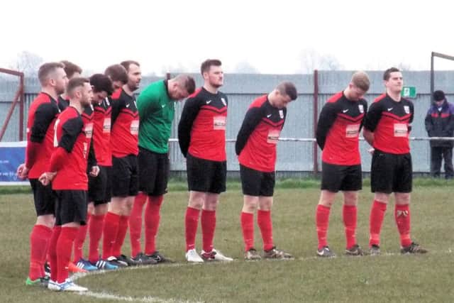 PAYING THEIR RESPECTS -- Teversal players observe a minutes silence ahead of Saturdays match after the grieving club was hit by tragedy.