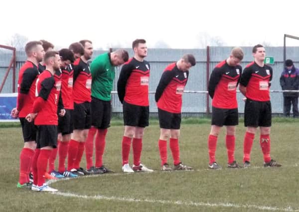 PAYING THEIR RESPECTS -- Teversal players observe a minutes silence ahead of Saturdays match after the grieving club was hit by tragedy.