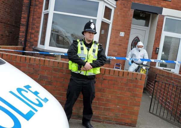 A police officer stands guard outside the double murder scene at 22 Station Road, Shirebrook, where police forensic teams were still at work on Monday.