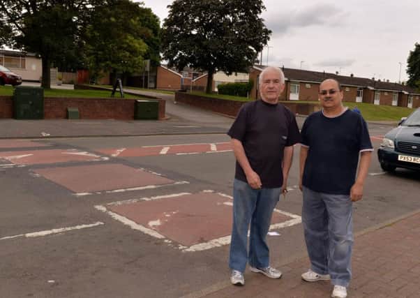 Ladybrook Lane shopkeepers  Terry Cook and Kalpesh Bhatt, have been campaigning to have the bumps removed.