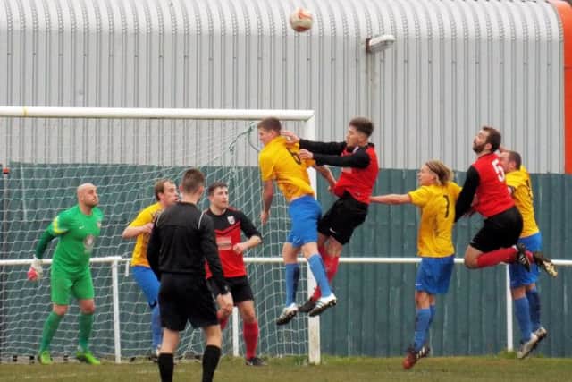 RISING HIGH -- forwards and defenders alike leap for the ball at a corner during Teversal's match at Bottesford Town last Saturday.