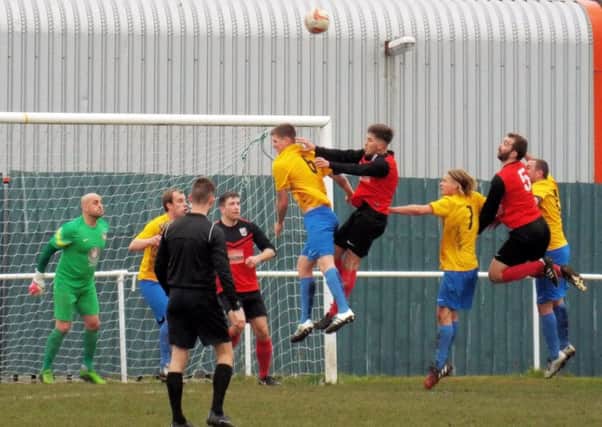 RISING HIGH -- forwards and defenders alike leap for the ball at a corner during Teversal's match at Bottesford Town last Saturday.