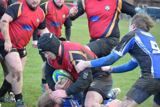 STOPPED IN HIS TRACKS -- Daz Jones feels the full force of the Grimsby opposition during depleted Ashfields 33-3 defeat in the National Leagues Midlands 3 East (North) division last Saturday when a host of injuries caught up with them.