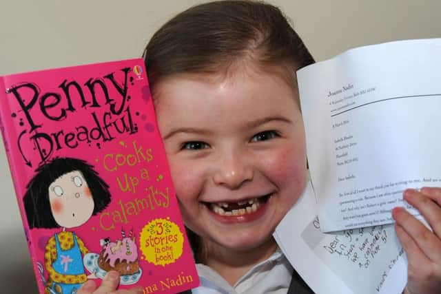 Isabella Rhodes with her signed book, reply letter and a copy of the letter that sparked an internet sensation after she wrote to author Joanna Nadin.