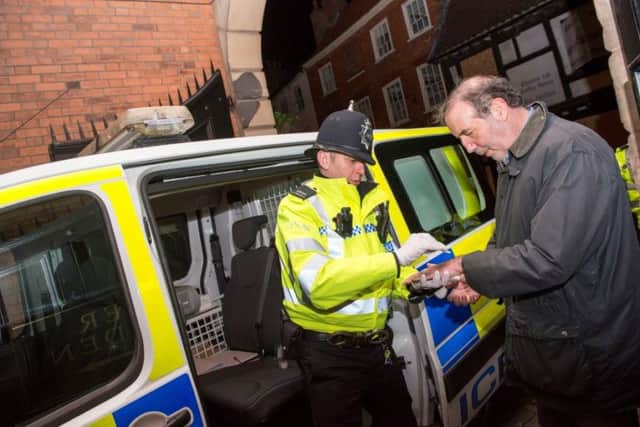 PC Gareth Nicholls shows Paddy Tipping Morpho drug testing