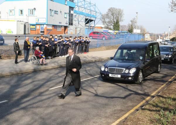 The funeral of Johnny Miller is applauded past Mansfield FC's ground