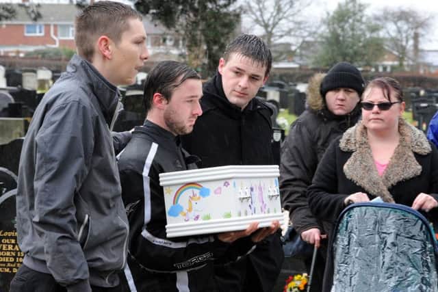 David Bennett carries the coffin of his baby daughter Tiger in Warsop Cemetery on Wednesday morning, supported by family and friends.