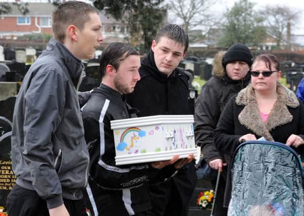 David Bennett carries the coffin of his baby daughter Tiger in Warsop Cemetery on Wednesday morning, supported by family and friends.