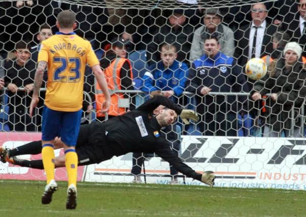 Mansfield Town v Portsmouth on Saturday March 19th 2016. Mansfield keeper Scott Shearer saves a penalty. Photo: Chris Etchells
