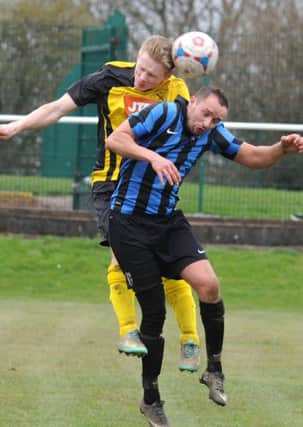 Hucknall midfielder Joe Ashurst (yellow) challenges Damien James, who netted the winner for Selston in the first-half.