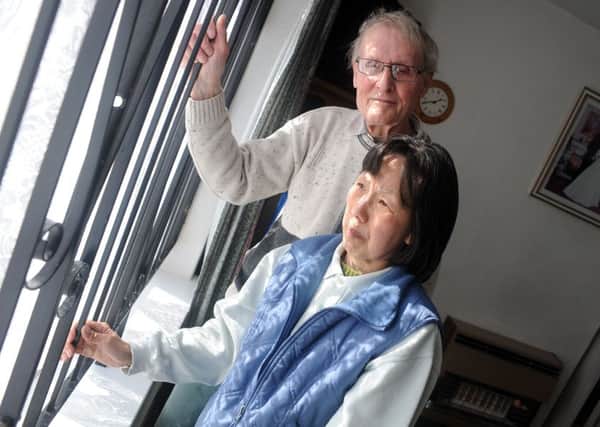 Dennis and  Lo Wai Buckley of Willow Crescent with the burglar bars that are on their Willow Crescent home.