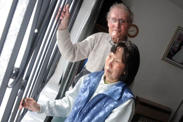 Dennis and  Lo Wai Buckley of Willow Crescent with the burglar bars that are on their Willow Crescent home.