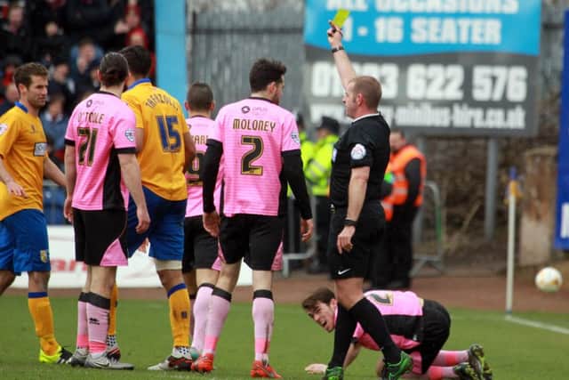 Mansfield Town v Northampton Town, Monday March 28th 2016. Mansfield player Ryan Tafazolli gets the yellow card. Photo: Chris Etchells
