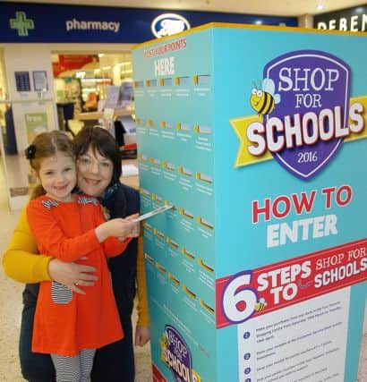Alison Clarke and her daughter Olivia, aged six, post their vouchers.