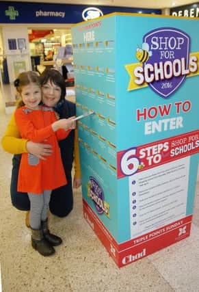Alison Clarke and her daughter Olivia, aged six, post their vouchers.