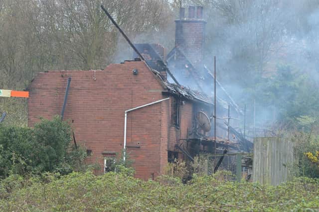 Parts of the roof and upper floor are removed to allow firefighters to search the ground floor. The operation is expected to take several days.