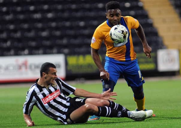 Notts County defender Haydn Hollis tussles with Adi Yussuf when the sides met earlier this season.