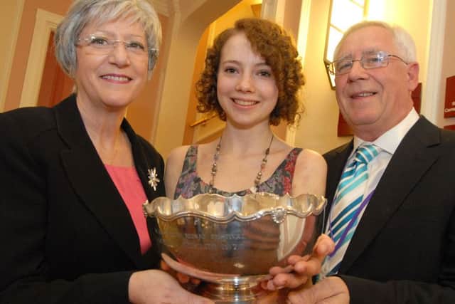 Coun. Kate Allsop and Paul Bacon, chairman of the Mansfield Music and Drama Festival, present the Jubilee Trophy for best Individual Performance to Lydia Ward (2012).