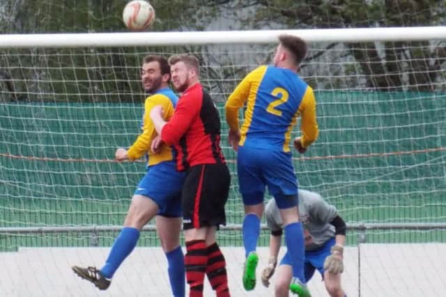 HEAD BANGERS -- Teversal defending valiantly during their 1-1 draw at Dronfield Town in the last match of their league season.
