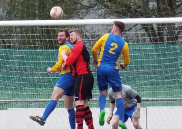 HEAD BANGERS -- Teversal defending valiantly during their 1-1 draw at Dronfield Town in the last match of their league season.